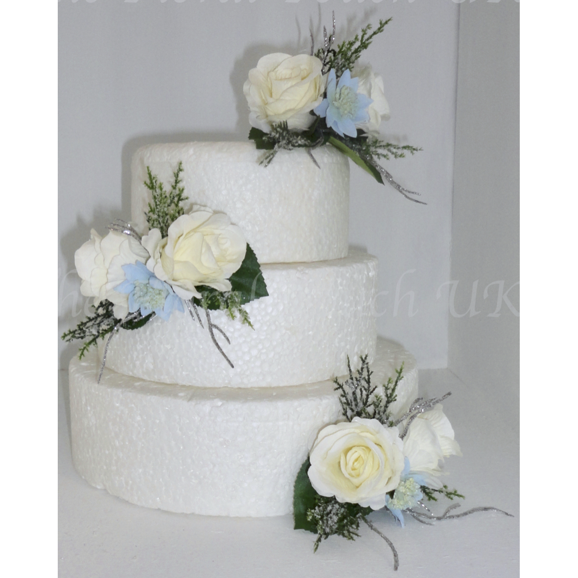 Ivory silk roses with pale blue Astrantia 

Cypress sparkly pine foliage with silver twig sprays